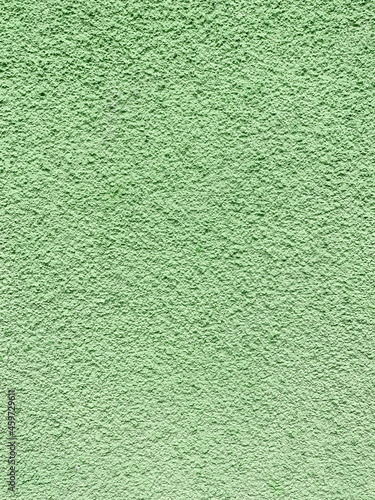 Colored, green concrete wall structure for background design or texture