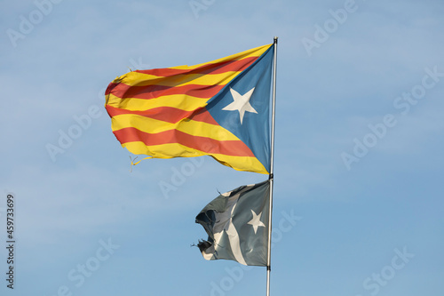 Flag and national symbol of the pro-independence Catalan people, known as estelada, waving in the town of Ginestar, province of Tarragona photo