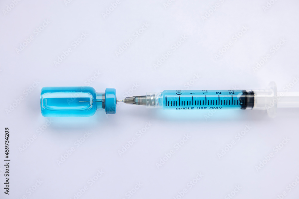 Close-up vials with vaccine and syringe for virus protection isolated on white background. Horizontal composition. Close-up vials with vaccine and syringe for virus protection isolated on white background. Horizontal composition.