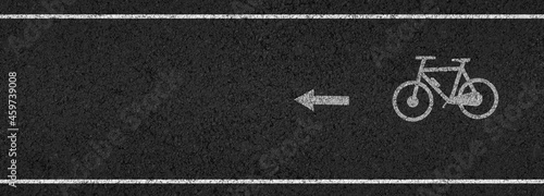 Fotografia Empty asphalt road with cycle track and bike sign white dividing lines safety fi