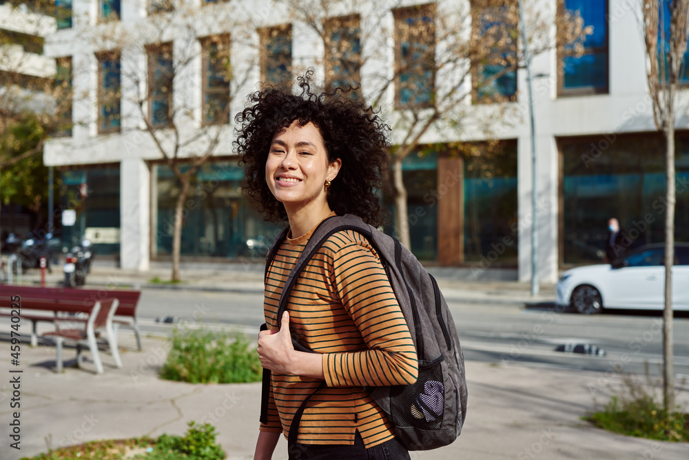 Fototapeta premium Cute young woman smiling at camera in the city
