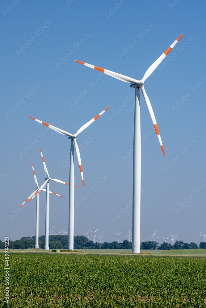 Modern wind turbines in front of a blue sky seen in Germany