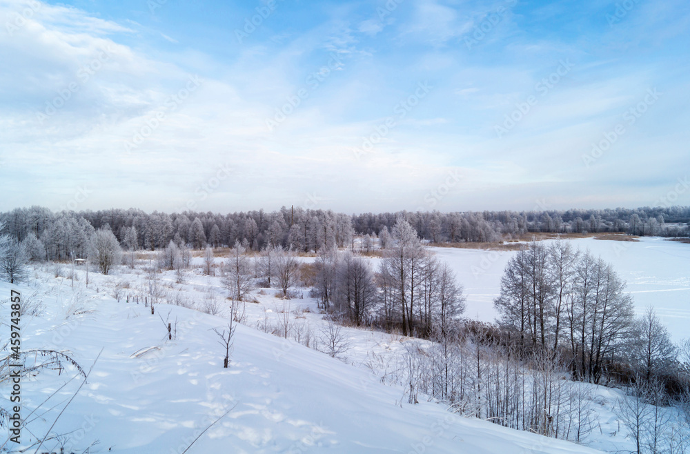 The Winter landscape with hilly terrain in Russia on turn blue the background a sky. The Winter landscape with hilly terrain in Russia on turn blue the background a sky.