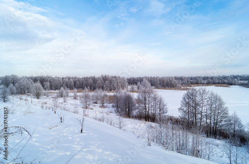 The Winter landscape with hilly terrain in Russia on turn blue the background a sky.