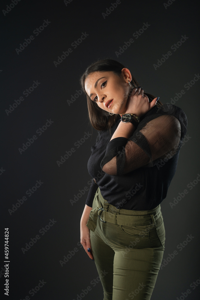 Portrait of beautiful model in black dress, hat and sunglasses on gray background Portrait of beautiful model in black dress, hat and sunglasses on gray background