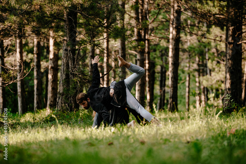 Summer forest activity fitness couple practicing dance on a field in the woods