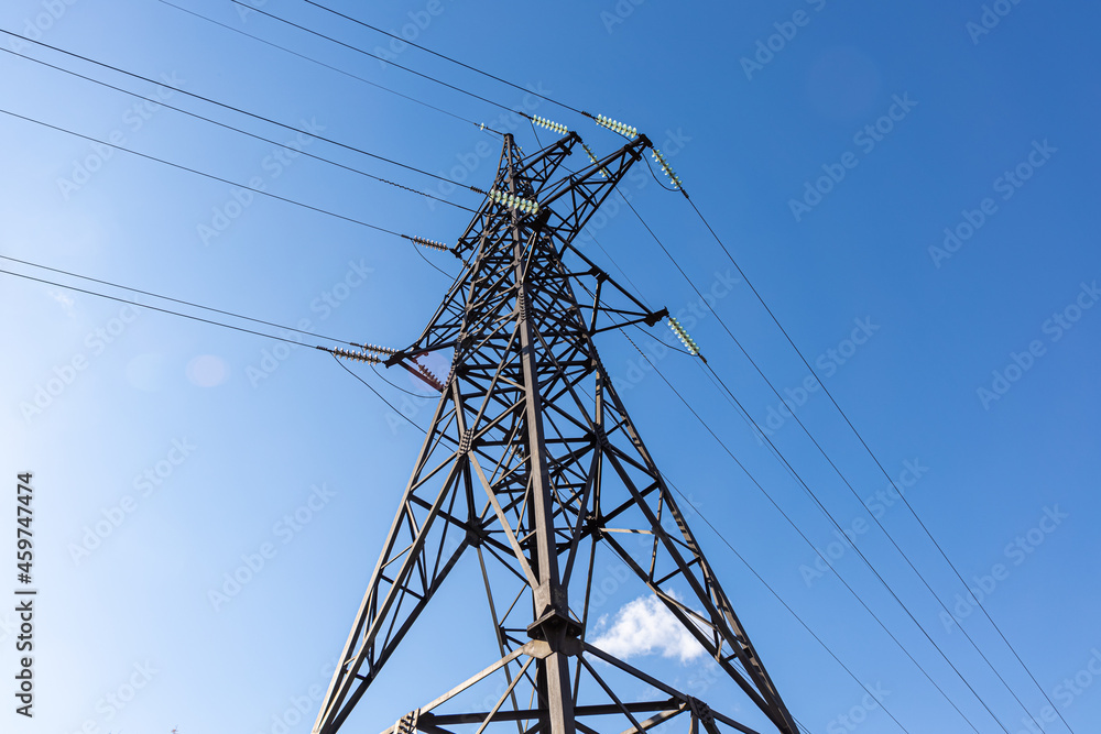 Rusty power line is on the blue sky background