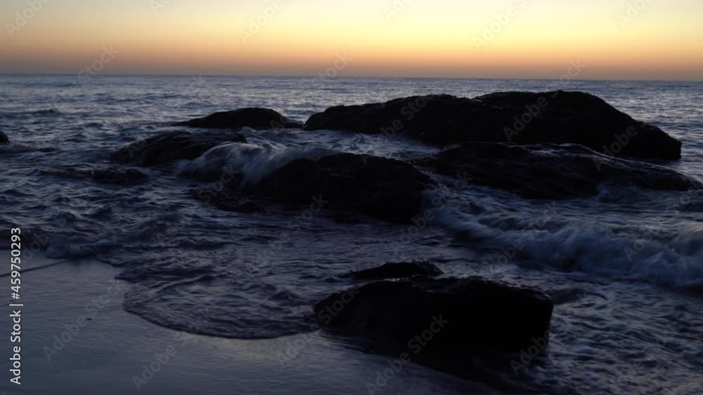 Waves breaking on the pebbles close up. Sea surf. Waves runs on coastal pebble. summer day sea and coast holiday concept Waves breaking on the pebbles close up. Sea surf. Waves runs on coastal pebble. summer day sea and coast holiday concept