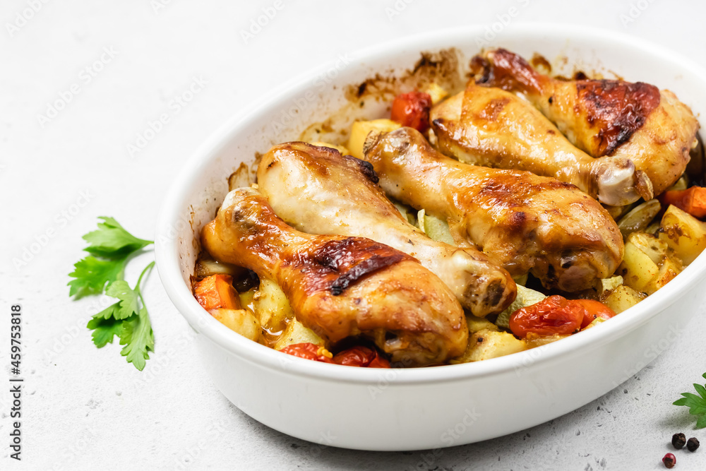 Honey mustard chicken legs with root vegetables in baking dish.Copy space. Honey mustard chicken legs with root vegetables in baking dish.Copy space.