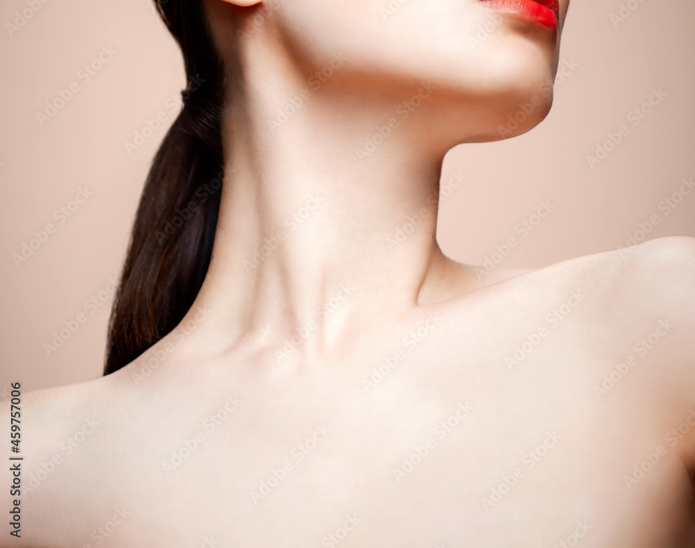 Women's chin, neck and collar bone on a nude background Women's chin, neck and collar bone on a nude background
