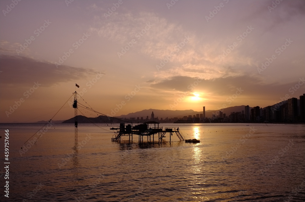 sunset over the sea with surfing tower at benidorm