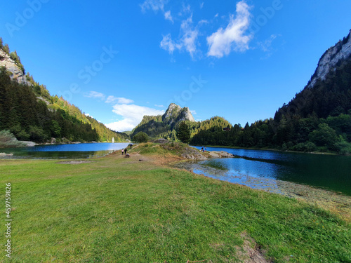 Deep-blue waters of Lac de Taney surrounded by the Jumelles twin peaks photo