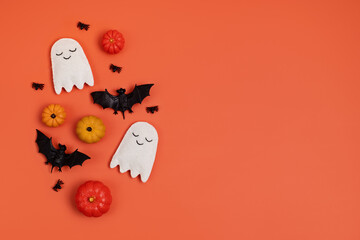 Top view of Halloween decoration with pumpkins, bats, ghosts. Party, invitation, halloween decoration concept. Flat lay, overhead, copy space.