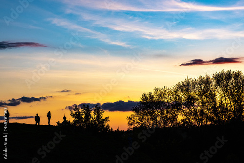 Silhouettes of people, trees and domes of churches on the beautiful sunset sky in Suzdal. © Valery Smirnov