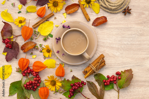 autumn composition cup of coffee on a table with flowers and leaves, top view, background picture