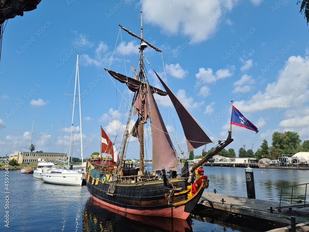 The reconstructed wooden sailing ship Libava docked at the pier in the Latvian port of Riga on a hot summer day in 2021 The reconstructed wooden sailing ship Libava docked at the pier in the Latvian port of Riga on a hot summer day in 2021