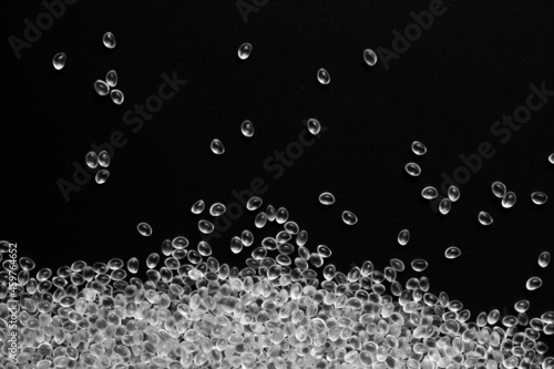 White granules of rubber, polypropylene or polyamide on a black background.