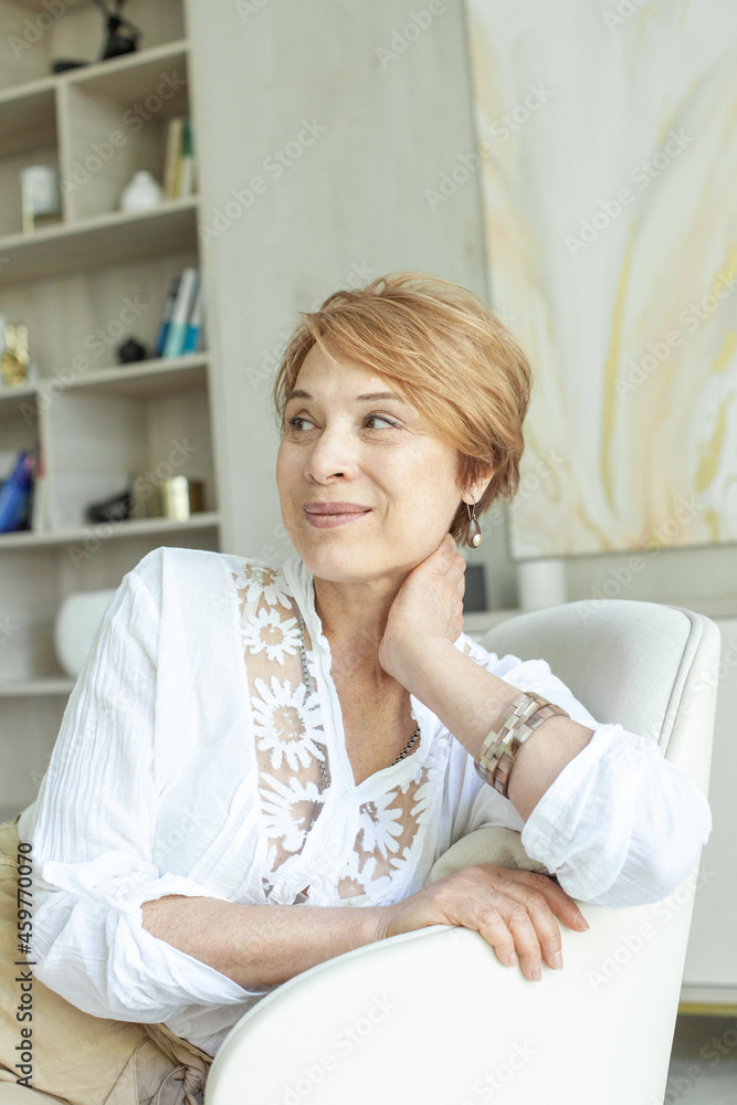 Cheerful mature woman smiling and looking aside Cheerful mature woman smiling and looking aside