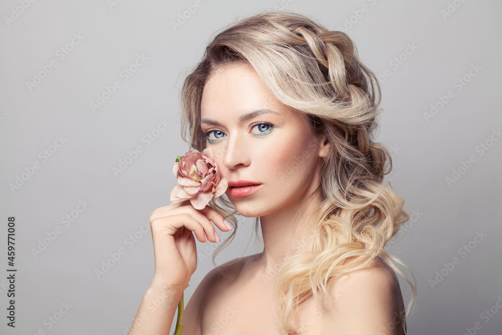 Young woman touching her healthy skin. Photo of perfect female model on white background. Skin care concept