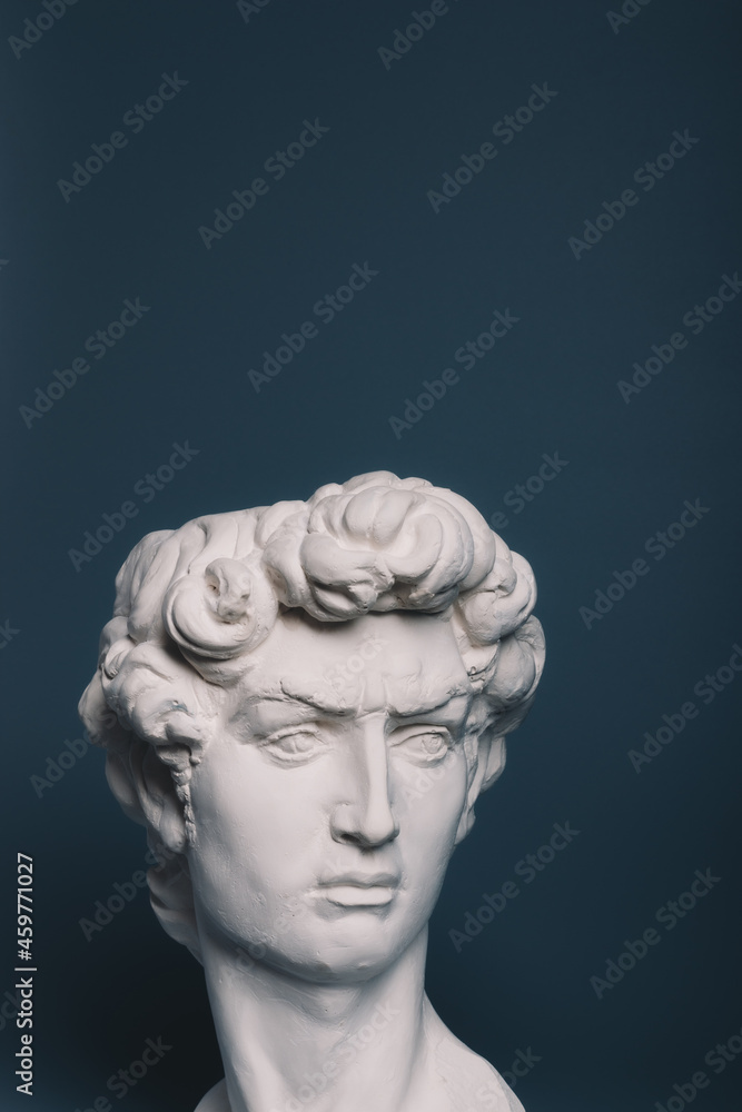 Gypsum copy of the sculpture David Michelangelo on gray background