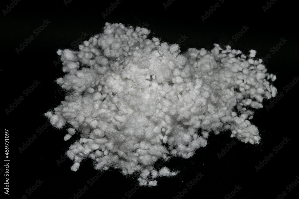 Synthetic fiber, polyester fiber, white synthetic winterizer on a black background, siliconized holofiber. It is used as a filler for blankets, pillows, clothes and upholstered furniture. Synthetic fiber, polyester fiber, white synthetic winterizer on a black background, siliconized holofiber. It is used as a filler for blankets, pillows, clothes and upholstered furniture.