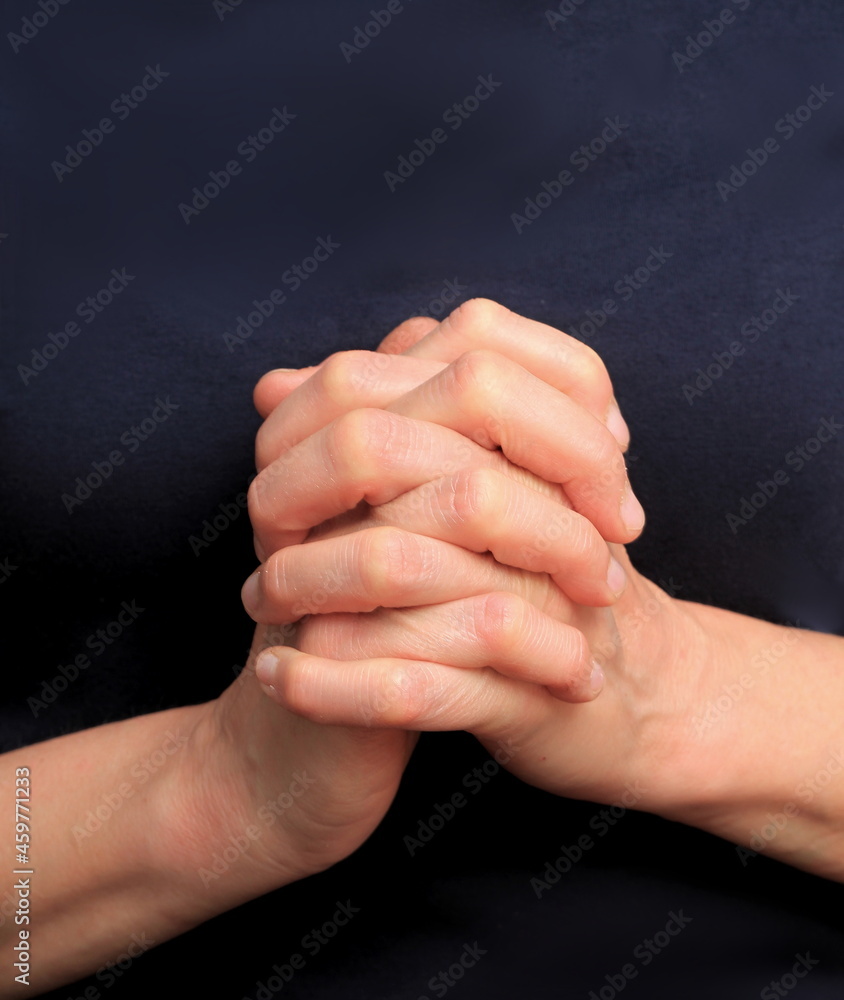 hands praying together on black background stock photo hands praying together on black background stock photo