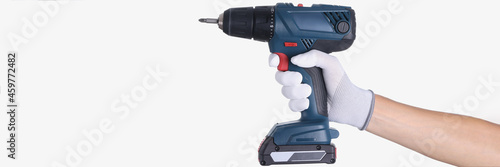 Schilderij op canvas Master in glove holds a drill with drill on white background