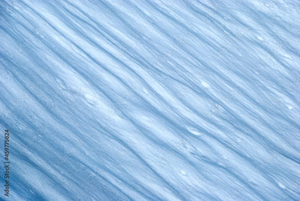 Obraz premium Textured snow shiny light and shadows after wind. Winter background. Abstract background, texture pattern, snowy crater, icy landscape after blizzard.