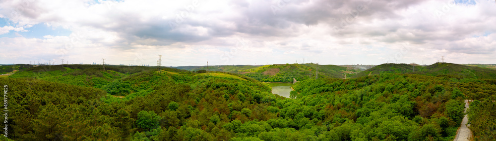 Panoramic view of Kemerburgaz City Forest in Istanbul. Dramatic clouds and forest with lake. 