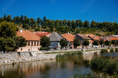 Trebic, Bohemia, Czech Republic, 06 July 2021: Narrow picturesque street with colorful buildings in historic center in medieval city, renaissance and baroque Jewish quarter at summer sunny day