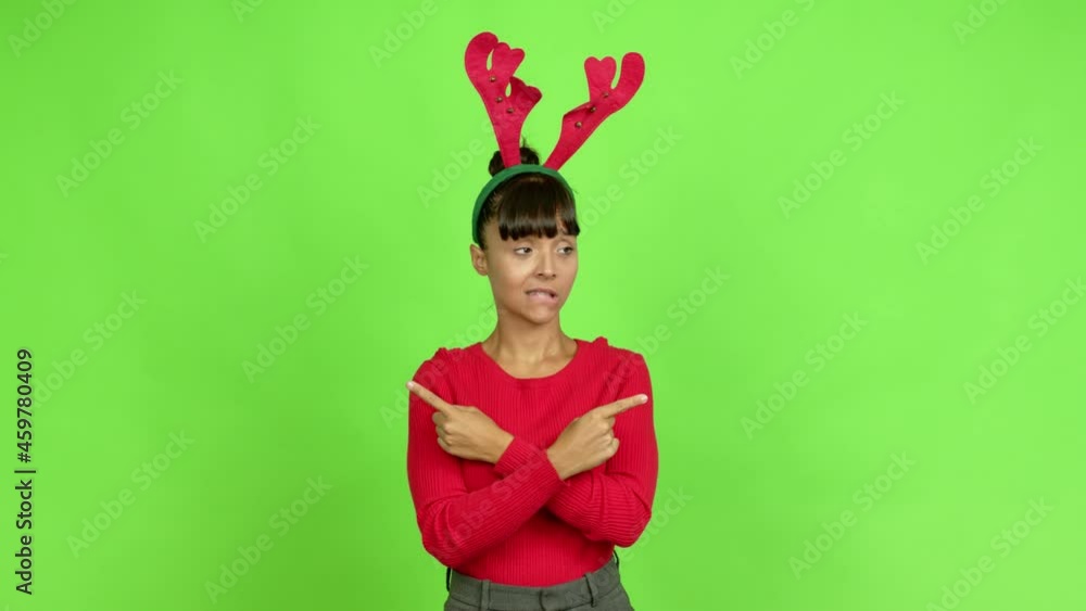 Young Woman Wearing Christmas Hat Pointing To The Laterals Having