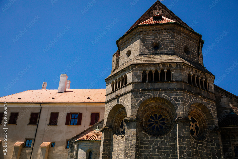 Obraz premium Trebic, Bohemia, Czech Republic, 06 July 2021: medieval castle with museum in historic center, St. Procopius basilica and monastery Romanesque Gothic style, Benedictine herb garden, sunny summer day