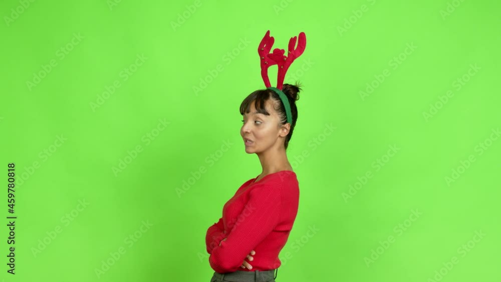 Young woman wearing christmas hat looking side over isolated background. Green screen chroma key Young woman wearing christmas hat looking side over isolated background. Green screen chroma key