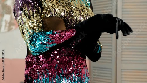 CU shot of Male in glitter dress is putting on gloves. Makeup Male in evening gown. 4k LGBT concept