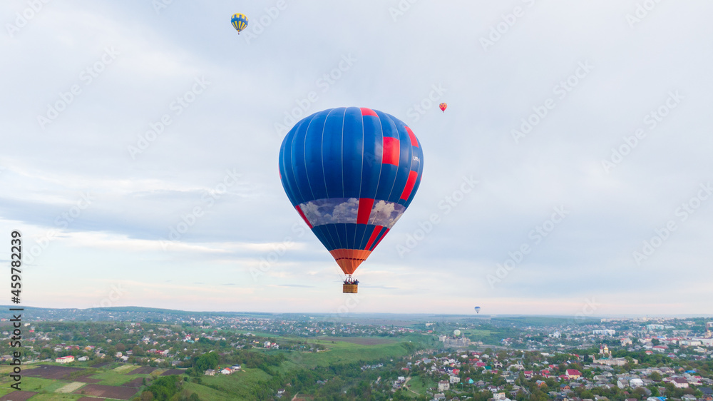 Fototapeta premium How to travel during quarantine. Hot air balloon. Colorful hot-air balloons flying over the village