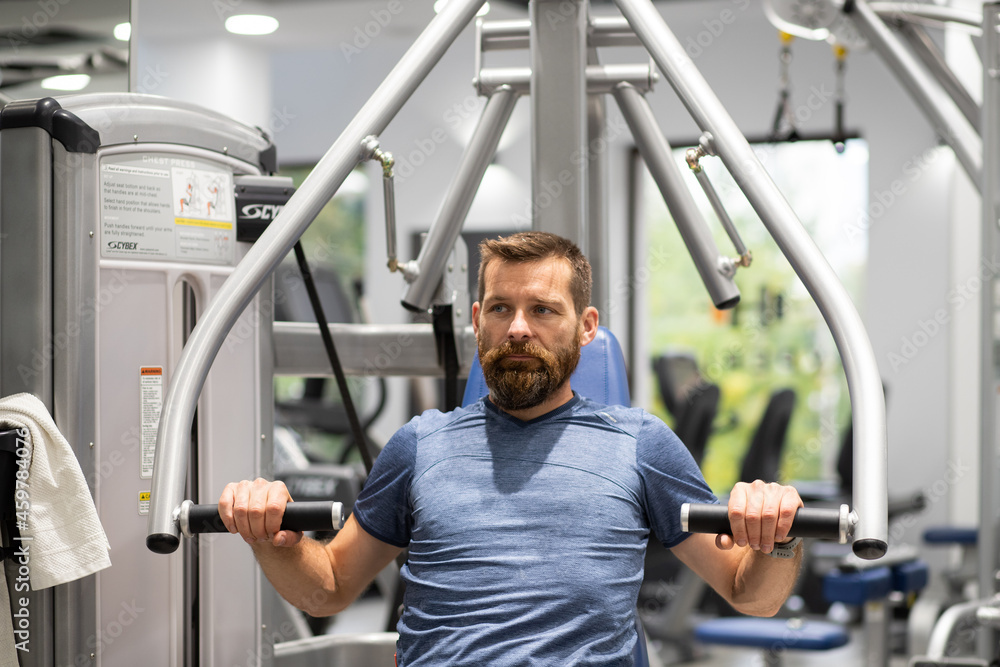 fit young man in sportswear trainings in a gym healthy active lifestyle fit young man in sportswear trainings in a gym healthy active lifestyle