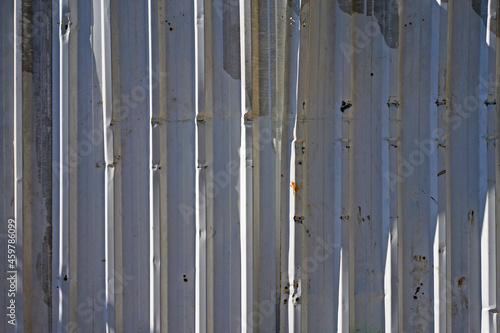 Corrugated metal plates surrounding wasteland 
