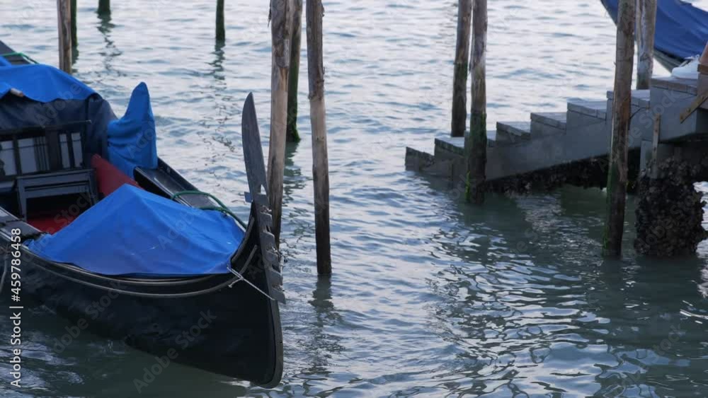 Gondolas on the water in Venice on a calm afternoon Gondolas on the water in Venice on a calm afternoon
