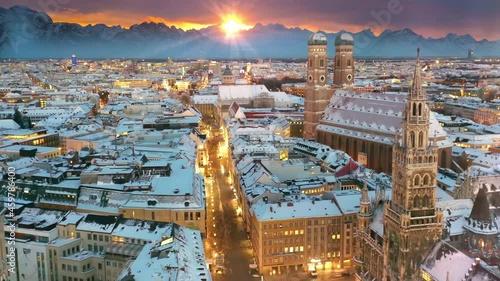 Beautiful munich city skyline aerial view at winter, munich drone footage germany covered with snow, fly over marienplatz town hall church frauenkirche at night. photo