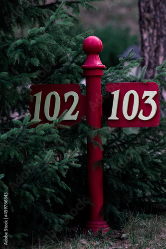 Parking number sign in a garden with nature in the background