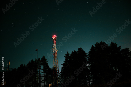 Night sky photo of a stary sky with an antenna tower