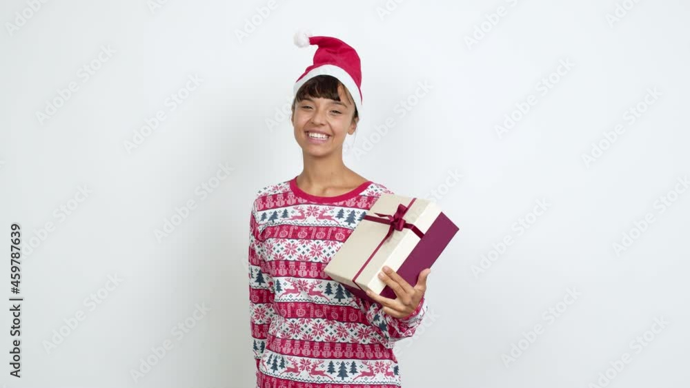 Young woman with christmas hat points finger at you with a confident expression over isolated background Young woman with christmas hat points finger at you with a confident expression over isolated background