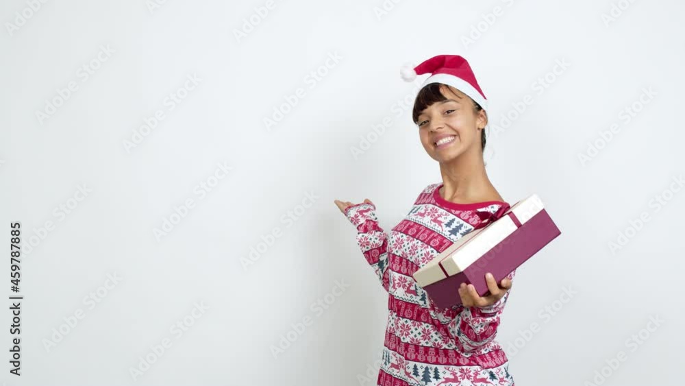 Young woman with christmas hat pointing back and presenting a product over isolated background Young woman with christmas hat pointing back and presenting a product over isolated background