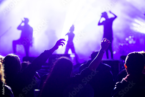 crowd at concert and silhouettes in stage lights