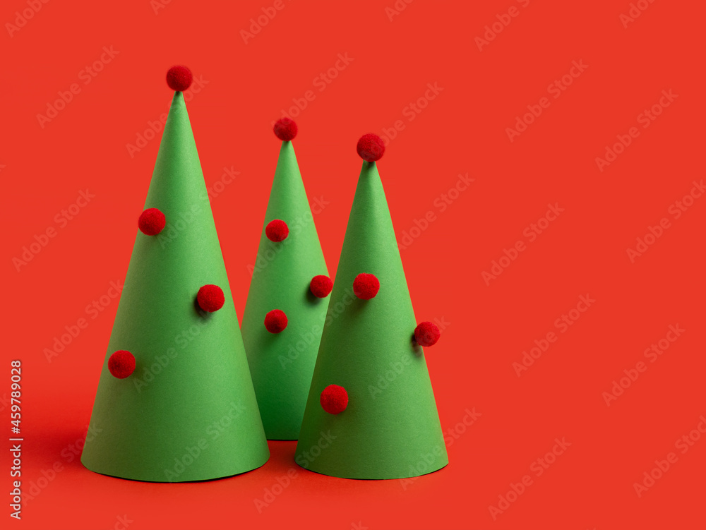 New Year's card. Christmas tree made of paper on a bright, red background. symbol of the new year New Year's card. Christmas tree made of paper on a bright, red background. symbol of the new year