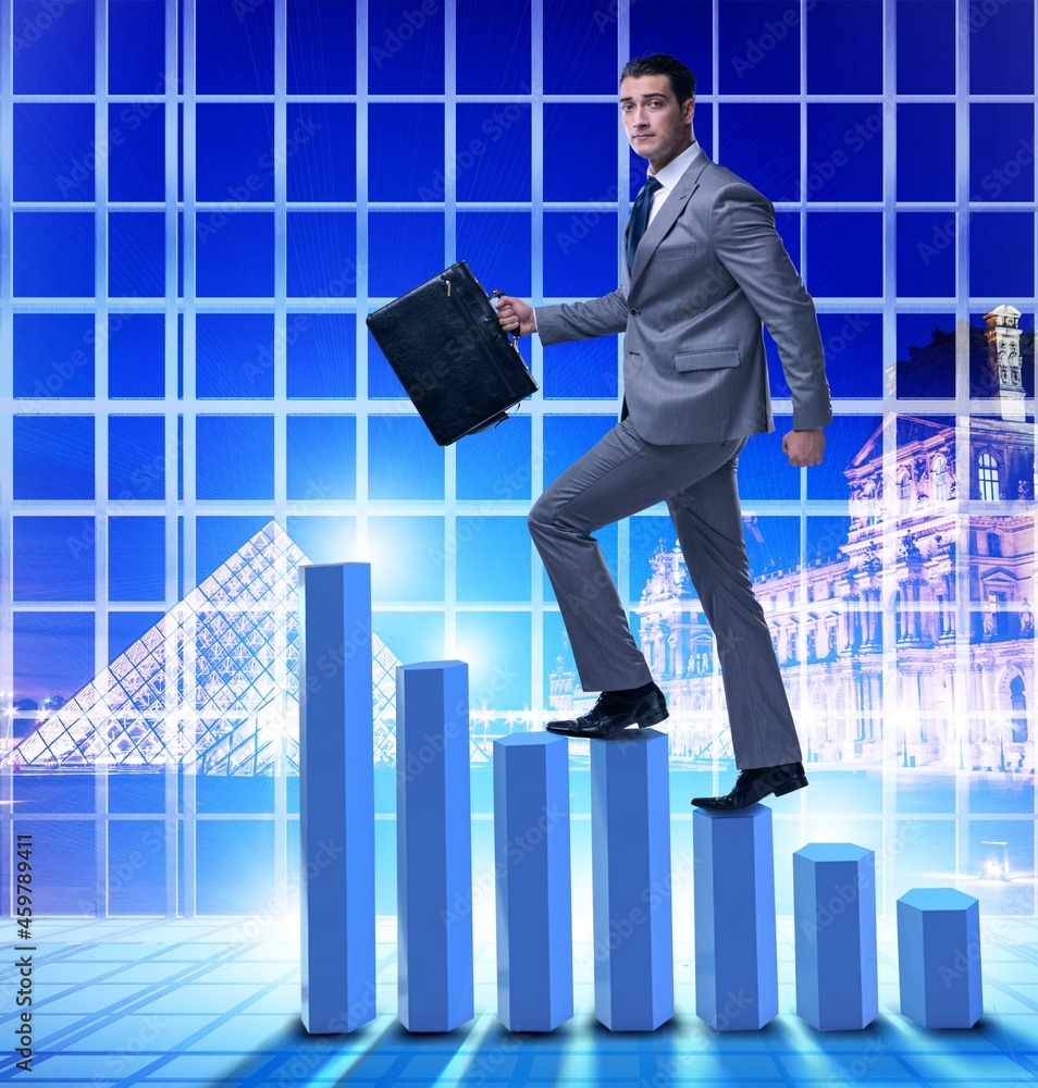 Businessman climbing bar charts in business concept Businessman climbing bar charts in business concept