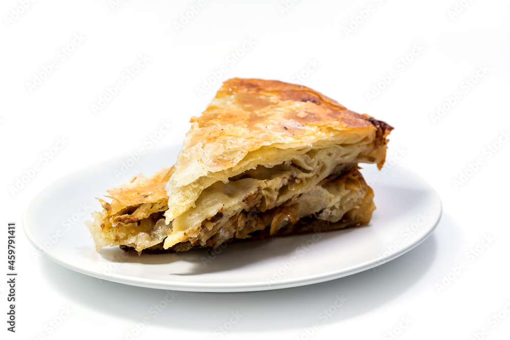 Burek Traditional Pie With Meat Served On The Plate. Traditional Balkan breakfast. Isolated on white background with clipping path included