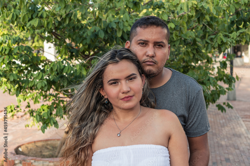 Stock Photography Portrait Of A Hispanic Couple In Front Of A Tree Outdoors. Stock Photography Portrait Of A Hispanic Couple In Front Of A Tree Outdoors.