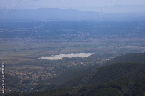 view from the top of the mountain to the city of Capannori , lake della Gherardesca and its surroundings in Italy in early autumn