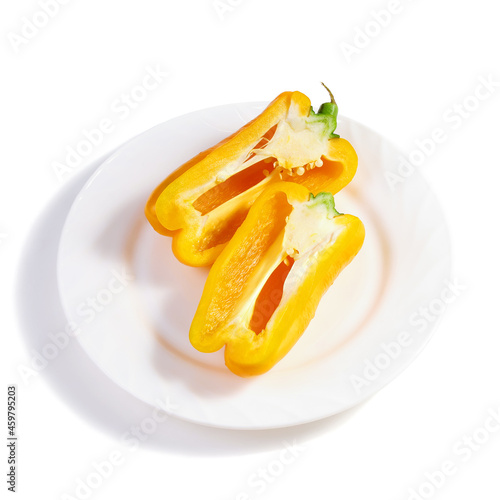 Two halves of yellow sweet bell peppers on white plate
